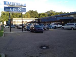 a parking lot with cars parked in front of a store at Eastglen Inn in Edmonton