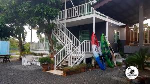 two surfboards are parked outside of a house at RIVERVIEW HOMESTAY PERLIS in Kangar