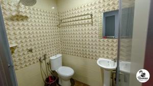 a bathroom with a toilet and a sink at RIVERVIEW HOMESTAY PERLIS in Kangar