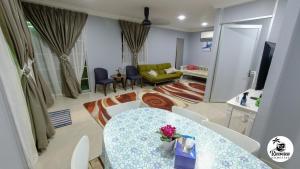 a living room with a table and a couch at RIVERVIEW HOMESTAY PERLIS in Kangar