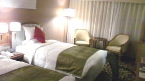 מיטה או מיטות בחדר ב-ANA Crowne Plaza Hotel Nagasaki Gloverhill, an IHG Hotel