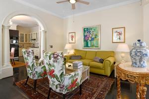 a living room with a couch and a table and chairs at Auberge Daniella in Franschhoek