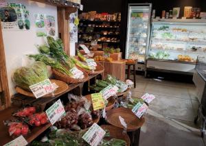 a store with vegetables on display in a market at Ryokan Shimizu in Kyoto