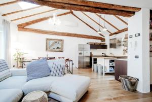 un soggiorno con divano bianco e una cucina di House Of Dreams - The House Of Travelers a Como