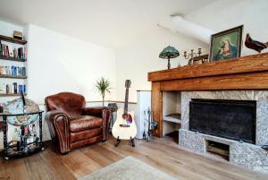 a living room with a chair and a fireplace at House Of Dreams - The House Of Travelers in Como