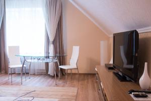 a living room filled with furniture and a tv at Meridian-Yug Hotel in Krasnyy Kolos
