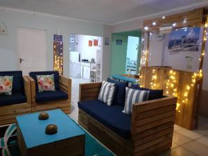 a living room with couches and a table and lights at Zufike Pondoland Wild Coast- Port Grosvenor in Lusikisiki