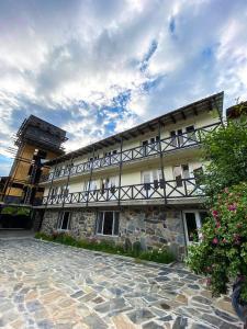 a building with balconies on the side of it at Family Hotel Kala in Mestia