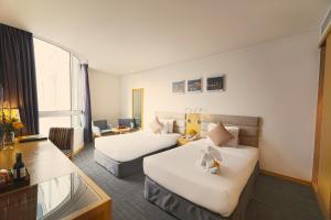 a hotel room with two beds and a window at Liberty Central Saigon Centre Hotel in Ho Chi Minh City