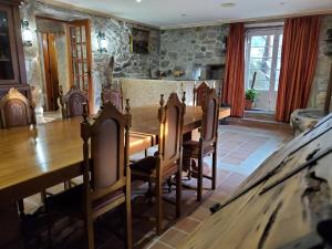 a dining room with a wooden table and chairs at CASA O´PACIÑO in Vigo