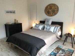 a bedroom with a large bed and a black dresser at Schöne Ferienwohnung nahe Heidelberg in Bammental