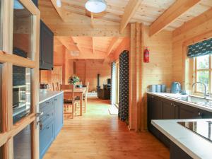 a kitchen with wooden walls and wooden flooring at Tythe Lodge in Sleaford