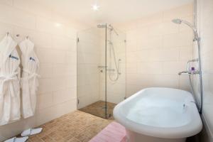 a bathroom with a shower and a white tub at Hämeenkylän Kartano in Vantaa +96 photos