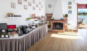 a room with a long table with a fireplace at Villa Ori B&B in Bocca di Magra