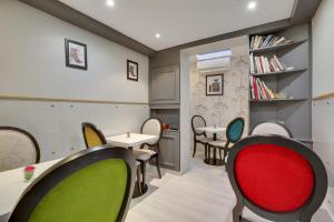 a waiting room with chairs and tables at Hotel Riviera Elysees in Paris