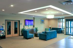 a hospital waiting room with blue chairs and a lobby at Comfort Inn & Suites Sikeston I-55 in Sikeston