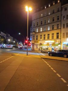 a city street at night with a street light at Mir hostel in Berlin
