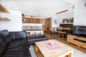 a living room with a couch and a table at Ferienwohnung Königsleiten 111 in Königsleiten