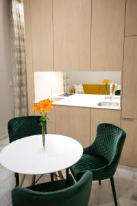 a kitchen with a table and chairs and a sink at Plazuela del Carbón Suites in Cádiz