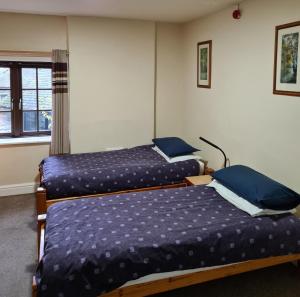 A bed or beds in a room at FSC Blencathra Hostel