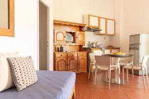 uma cozinha com uma mesa e uma cozinha com uma sala de jantar em Isola Rossa · Villetta Isola Rossa con spiaggia&piscina em Albinia