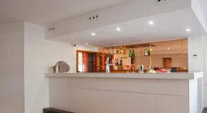 a kitchen with a bar in the middle of a room at Mix Peru Playa in Playa de Palma