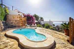 a swimming pool in the middle of a yard at Romantic Hamlet Cottage with Private Pool La Fragua de Eliseo in Candelaria
