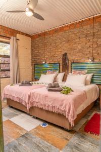 A bed or beds in a room at Otavi Vineyards Self-Catering & Camping