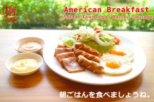 a plate of food with an egg on a table at Hinoki Hotel - ONSEN Chiang Mai in Chiang Mai