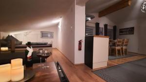 a woman standing in a living room with a dining room at Apartment Suzana in Umhausen