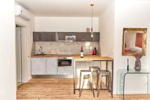 a kitchen with a counter and stools in a room at Apartmán NEWSTALGIE in Mikulov