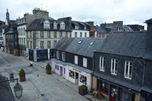 a city street with many buildings and a street with a street at nuit sur le pont 5 in Landerneau