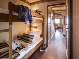 a room with two bunk beds and a hallway at Résidence l'Oxalys in Val Thorens