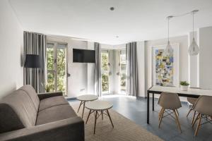 a living room with a couch and a table at Mon Suites Carmen in Valencia