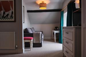 a living room with a couch and a tv at The Seagate in Appledore