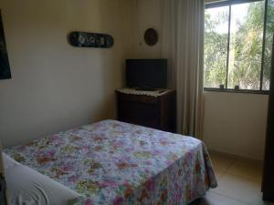Un pat sau paturi într-o cameră la Pousada das Orquideas Foz