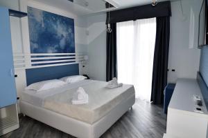 Ένα ή περισσότερα κρεβάτια σε δωμάτιο στο Hotel Calypso