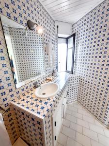 a bathroom with a sink and a mirror at Baby Boom - Duna Parque Group in Vila Nova de Milfontes