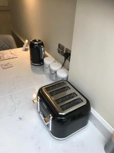 a toaster sitting on a counter in a room at Squirrel cottage in Cowling +23 photos