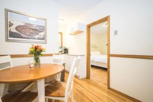 a dining room with a table and a bedroom at The Boston Rental - Multiple Floorplans in Boston