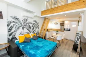 un petit appartement avec un canapé bleu dans une pièce dans l'établissement Duplex : Plage 300m, Clim, Netflix, à Cannes