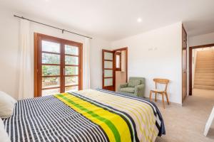 a bedroom with a bed and a chair and a window at Son Vivot Bill in Inca +17 photos