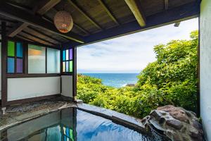 a house with a view of the ocean at Gardenvilla Shirahama in Shimoda