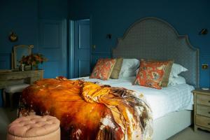 a bedroom with a large bed with a large comforter at The Angel Inn, Petworth in Petworth