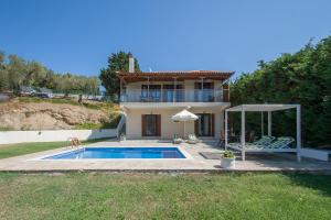 a villa with a swimming pool and a house at Four Seasons Villas in Skiathos Town