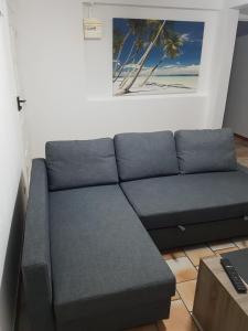 a blue couch in a living room at Appartement de la Baie in Le Vauclin