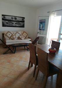 a living room with a table and a couch at Apartments Mistral Estoril Beach in Sal Rei