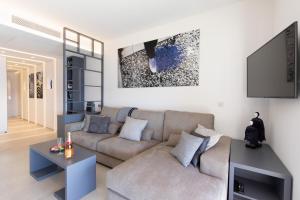 a living room with a couch and a tv at Blue Dreams YourHostHelper in Cannes