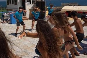 a group of young people in bathing suits dancing at Corvino Resort in Monopoli