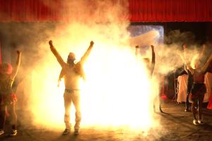 a group of people dancing on a stage with lights at Corvino Resort in Monopoli